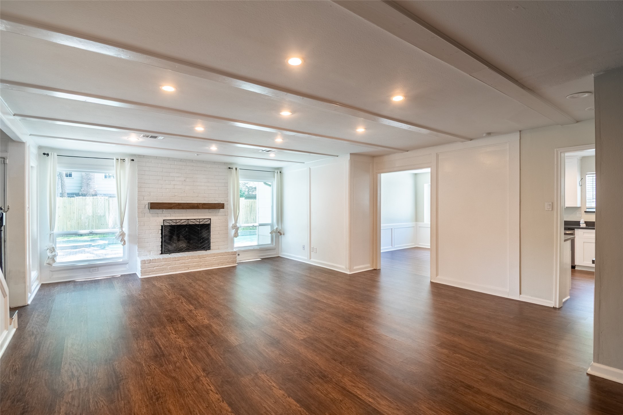 5607 Court Of York Houston, TX 77069 - Photo 8 of 45 a view of an empty room with wooden floor fireplace and a window