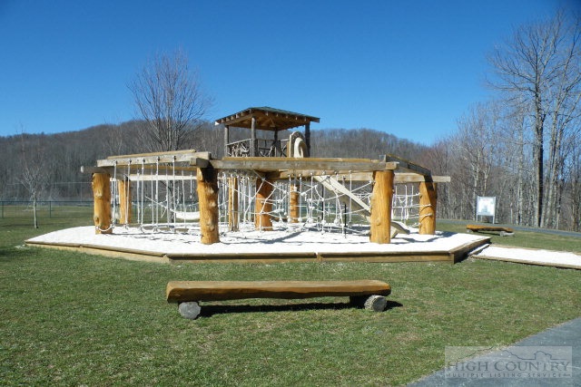 1459 Pine Ridge Road Beech Mountain, NC 28604 - Photo 12 of 25 a front view of a house with a yard table and chairs