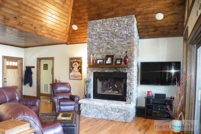 1459 Pine Ridge Road Beech Mountain, NC 28604 - Photo 2 of 25 a living room with furniture and a fireplace