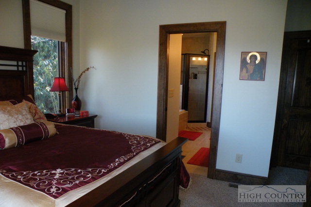 1459 Pine Ridge Road Beech Mountain, NC 28604 - Photo 21 of 25 a bed room with a bed and a mirror