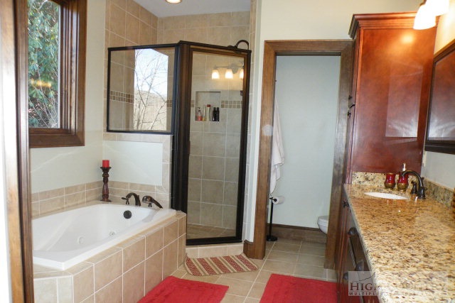 1459 Pine Ridge Road Beech Mountain, NC 28604 - Photo 23 of 25 a bathroom with a tub sink and mirror