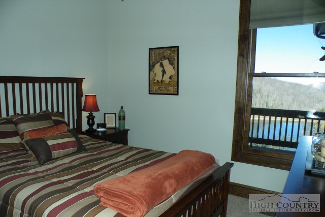 1459 Pine Ridge Road Beech Mountain, NC 28604 - Photo 25 of 25 a bedroom with a bed and wooden floor