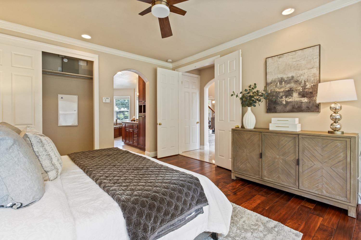 9003 Cedar Ridge Drive Granite Bay, CA 95746 - Photo 17 of 65 a spacious bedroom with a large bed a chandelier and closet