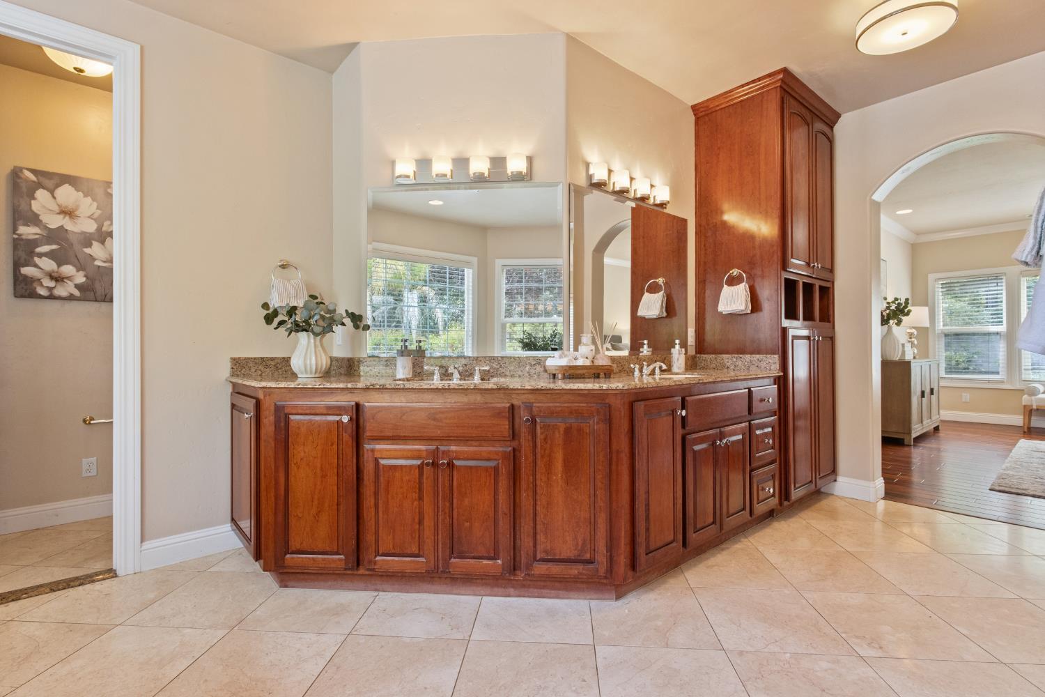 9003 Cedar Ridge Drive Granite Bay, CA 95746 - Photo 23 of 65 a bathroom with a granite countertop sink a mirror and a vanity
