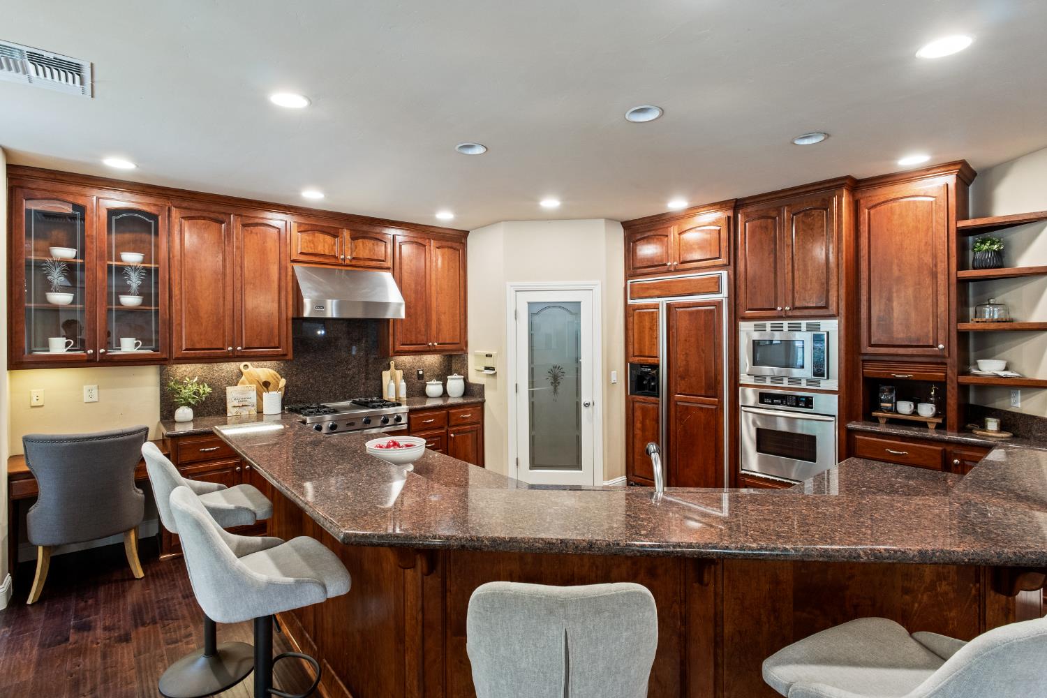 9003 Cedar Ridge Drive Granite Bay, CA 95746 - Photo 29 of 65 a kitchen with granite countertop a sink and chairs