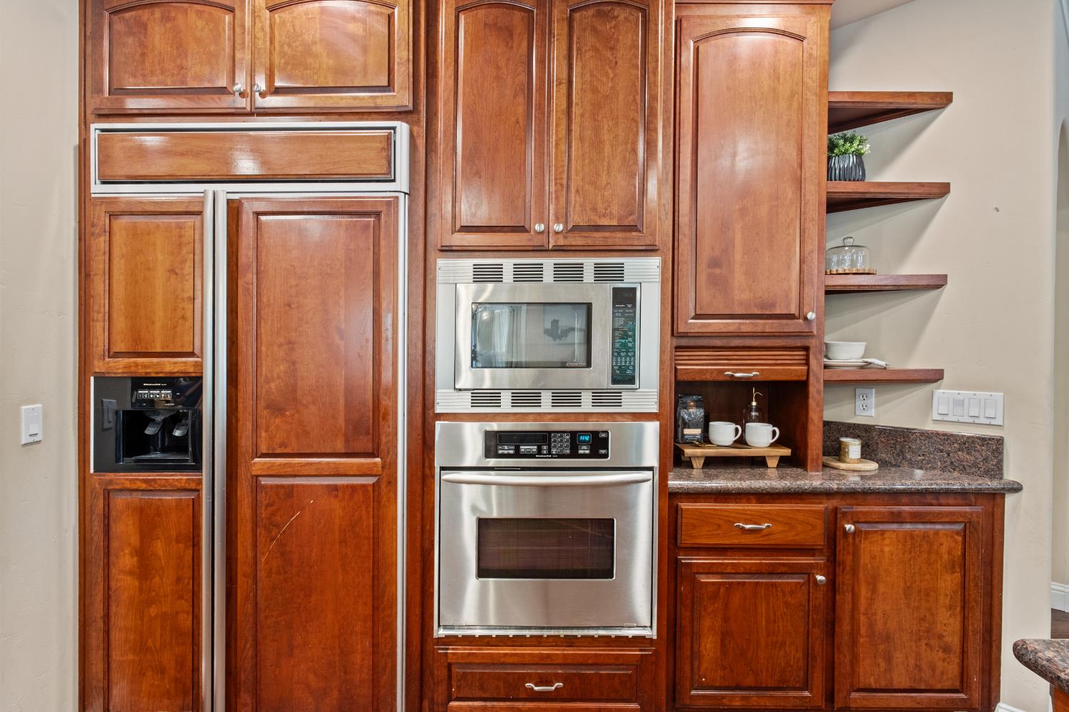 9003 Cedar Ridge Drive Granite Bay, CA 95746 - Photo 32 of 65 a kitchen with granite countertop cabinets and refrigerator