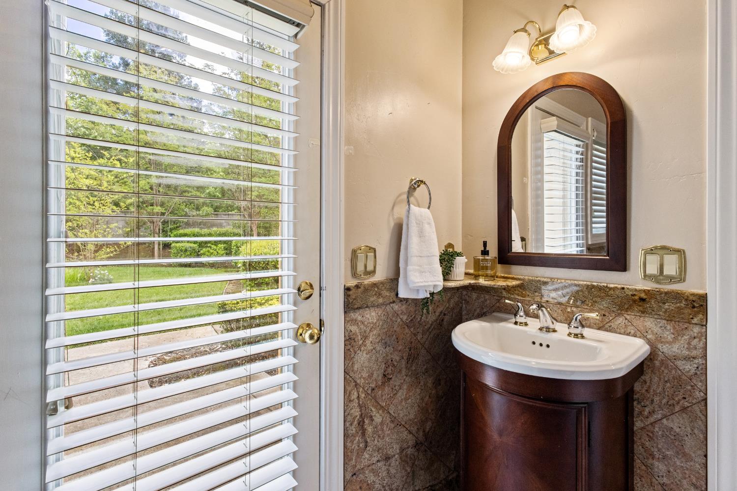 9003 Cedar Ridge Drive Granite Bay, CA 95746 - Photo 39 of 65 a bathroom with a sink and a mirror