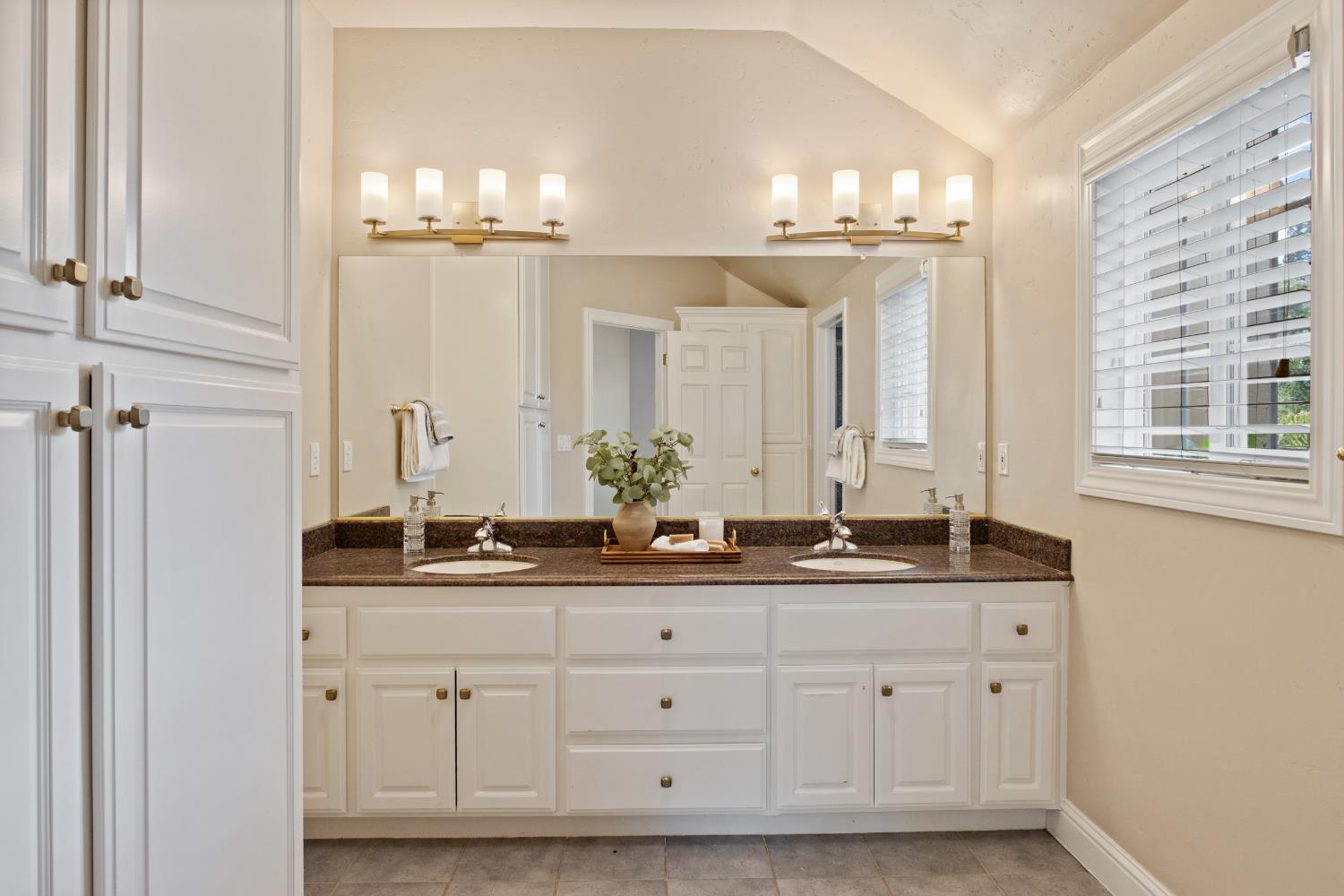 9003 Cedar Ridge Drive Granite Bay, CA 95746 - Photo 41 of 65 a bathroom with a double vanity sink and a mirror