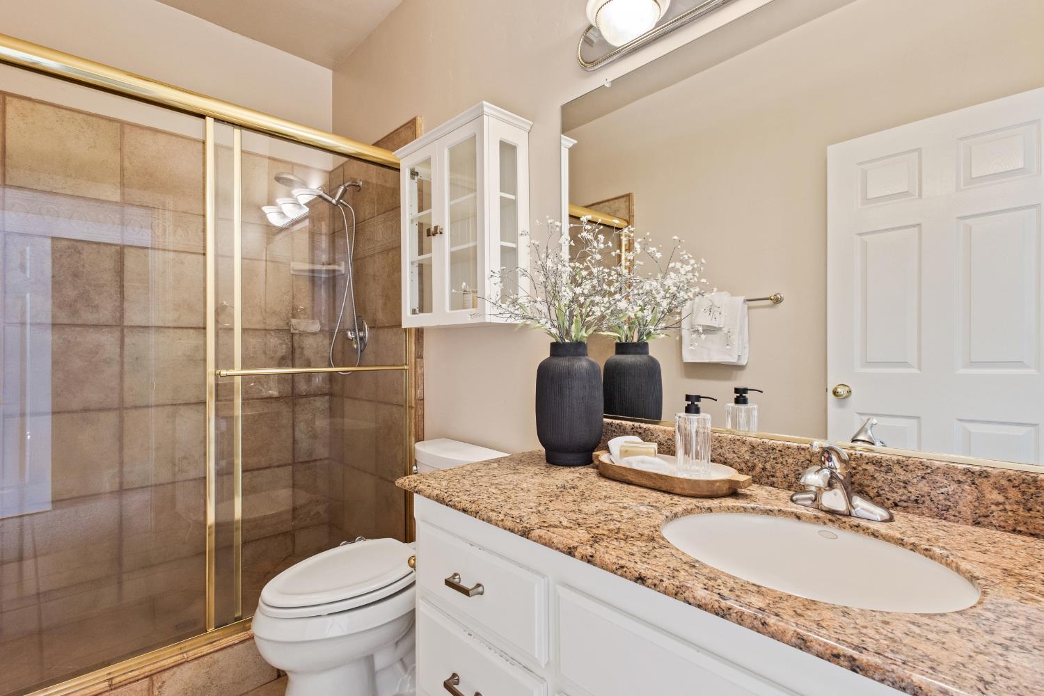 9003 Cedar Ridge Drive Granite Bay, CA 95746 - Photo 45 of 65 a bathroom with a granite countertop sink toilet and shower