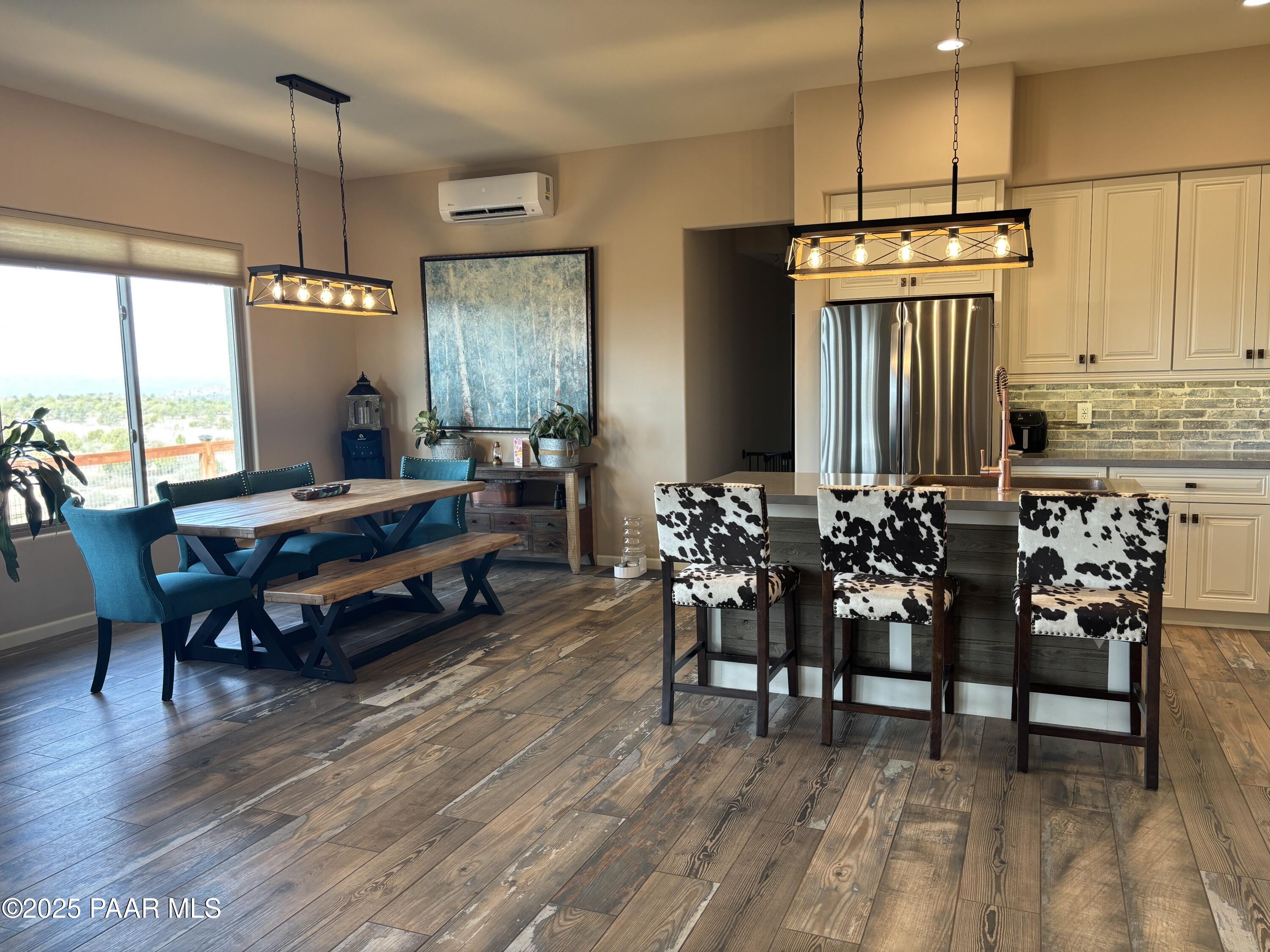14994 North Hope Rose Road Prescott, AZ 86305 - Photo 6 of 33 a living room with furniture a fireplace and a dining table with wooden floor