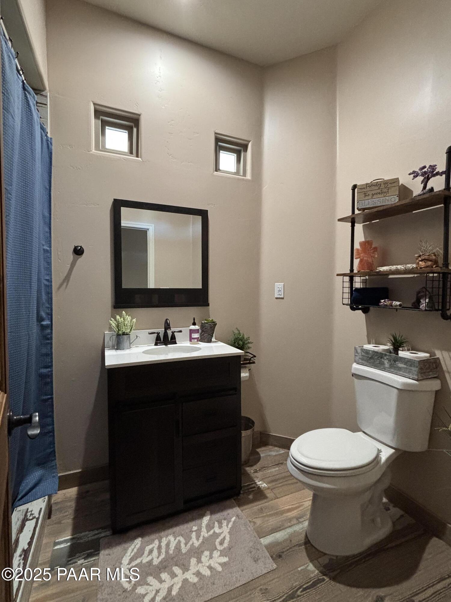 14994 North Hope Rose Road Prescott, AZ 86305 - Photo 9 of 33 a bathroom with a toilet a sink and mirror