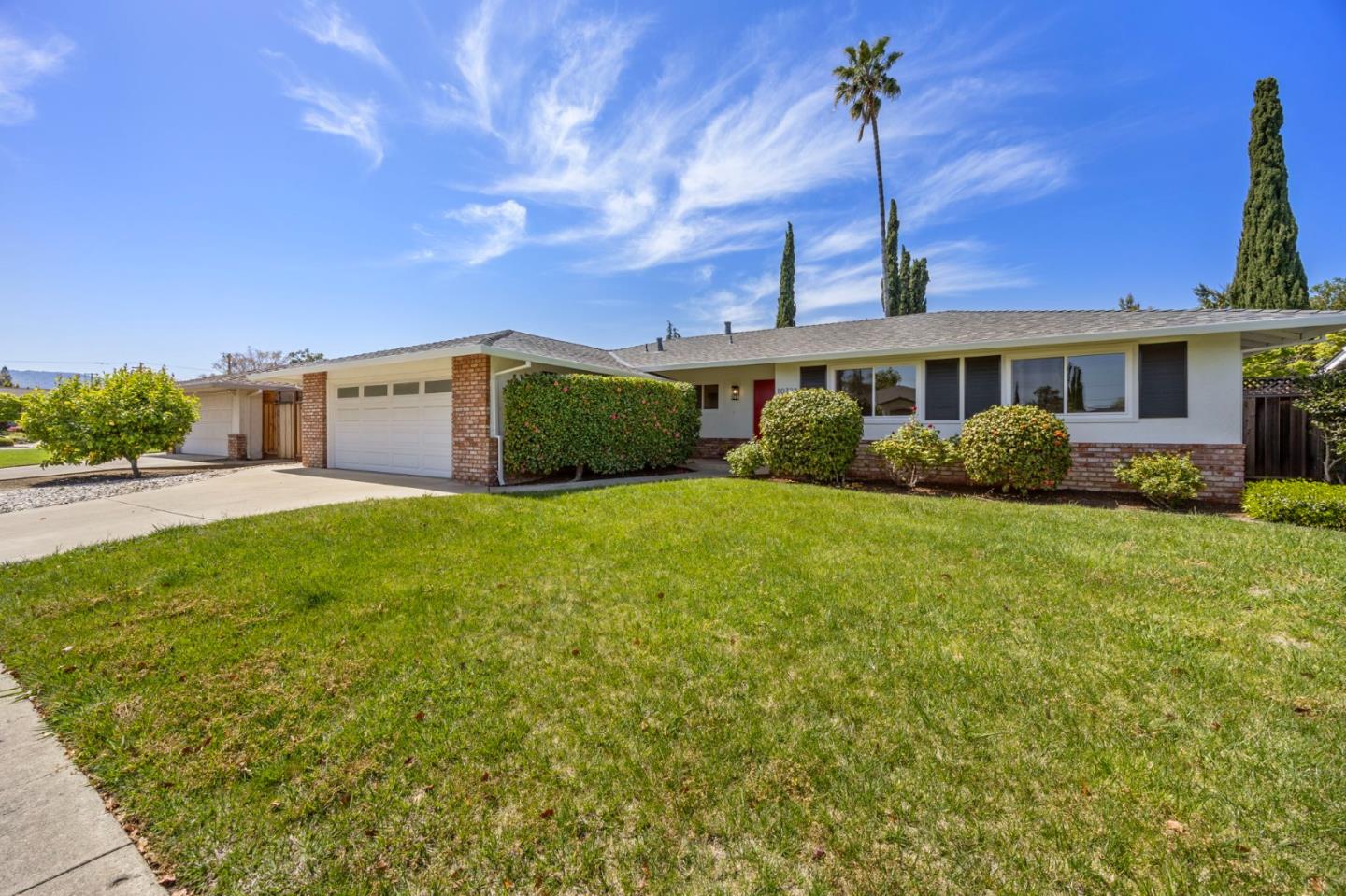 a front view of a house with garden