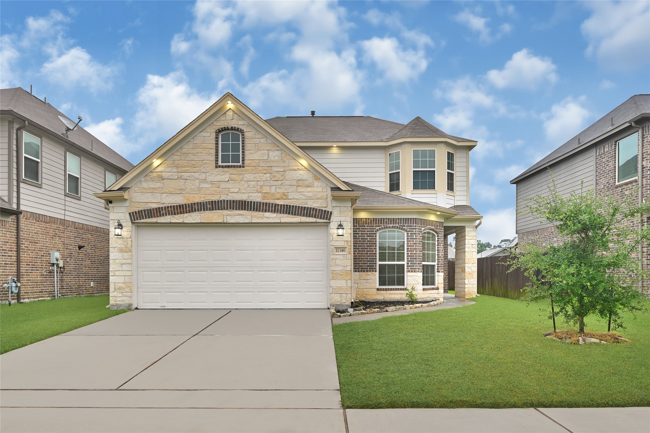 a front view of a house with a yard and garage