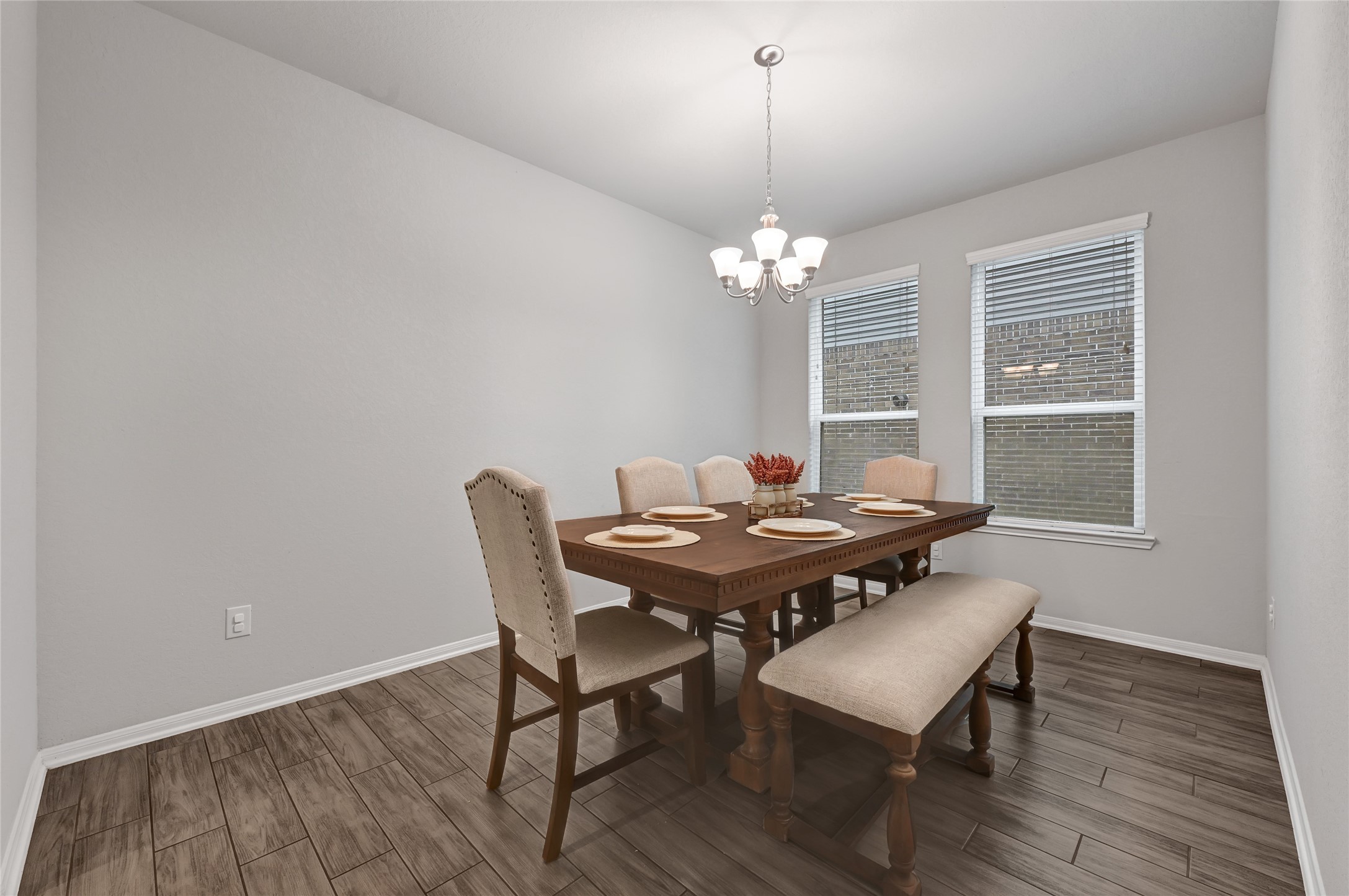 11346 Cascading Stream Way Houston, TX 77044 - Photo 11 of 24 a view of a dining room with furniture wooden floor and chandelier