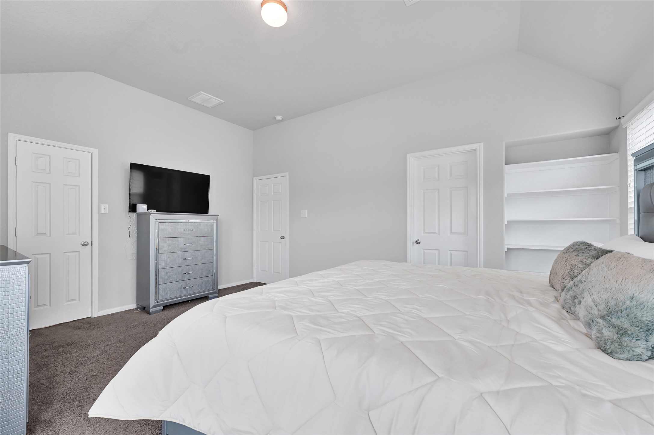 11346 Cascading Stream Way Houston, TX 77044 - Photo 13 of 24 a large bedroom with a bed and a flat screen tv