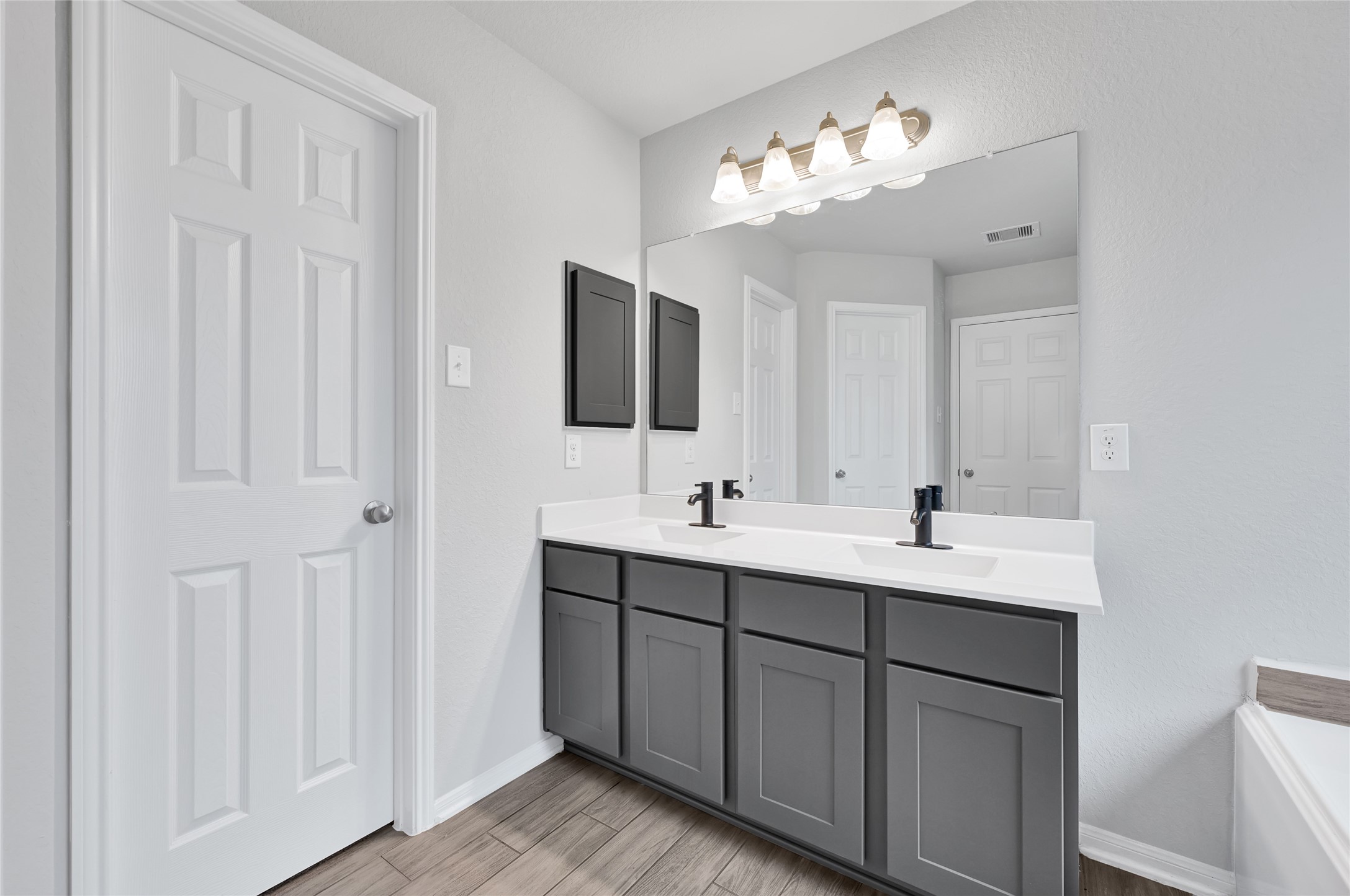 11346 Cascading Stream Way Houston, TX 77044 - Photo 15 of 24 a bathroom with a double vanity sink and a mirror