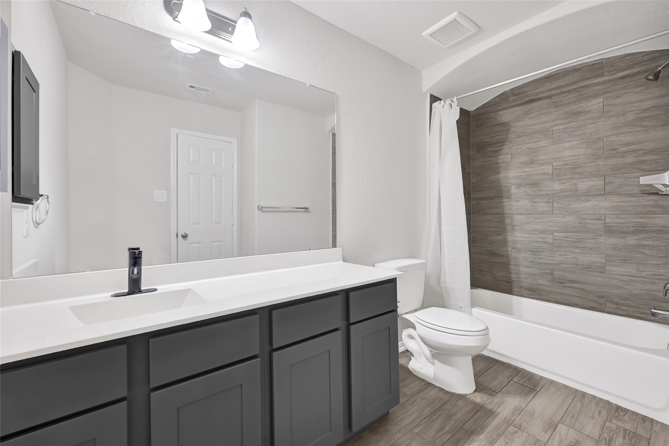 11346 Cascading Stream Way Houston, TX 77044 - Photo 17 of 24 a bathroom with a sink a toilet a mirror and shower