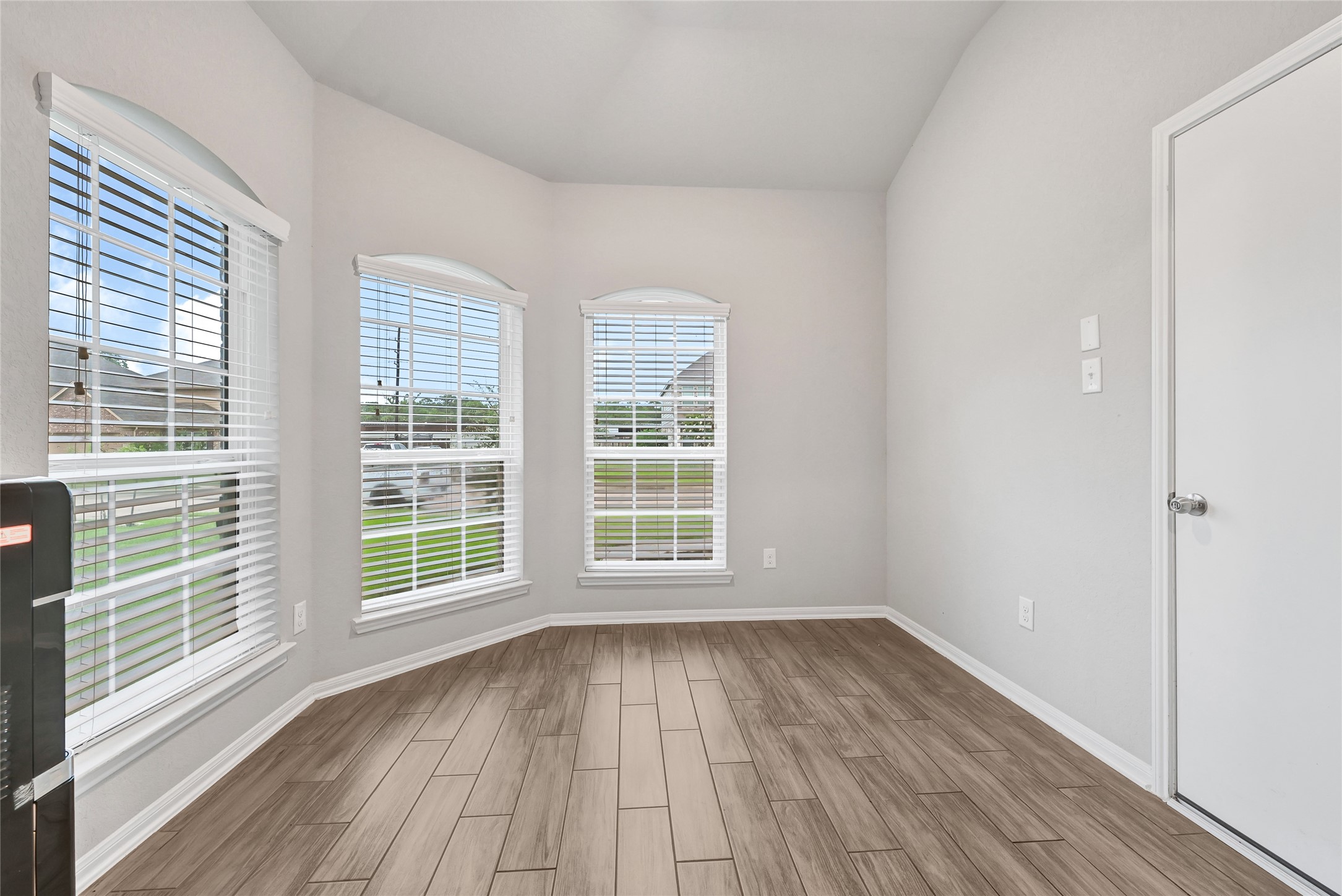 11346 Cascading Stream Way Houston, TX 77044 - Photo 8 of 24 a view of an empty room with wooden floor and a window