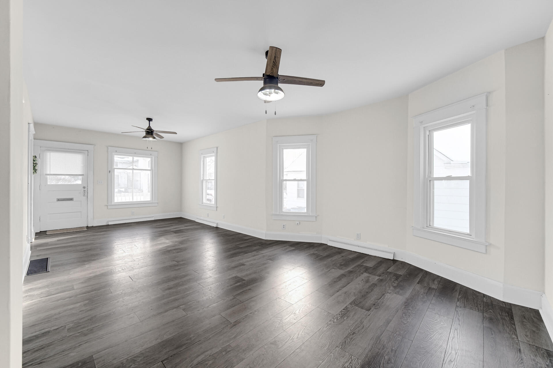 404 F Street La Porte, IN 46350 - Photo 13 of 35 an empty room with wooden floor ceiling fan and windows