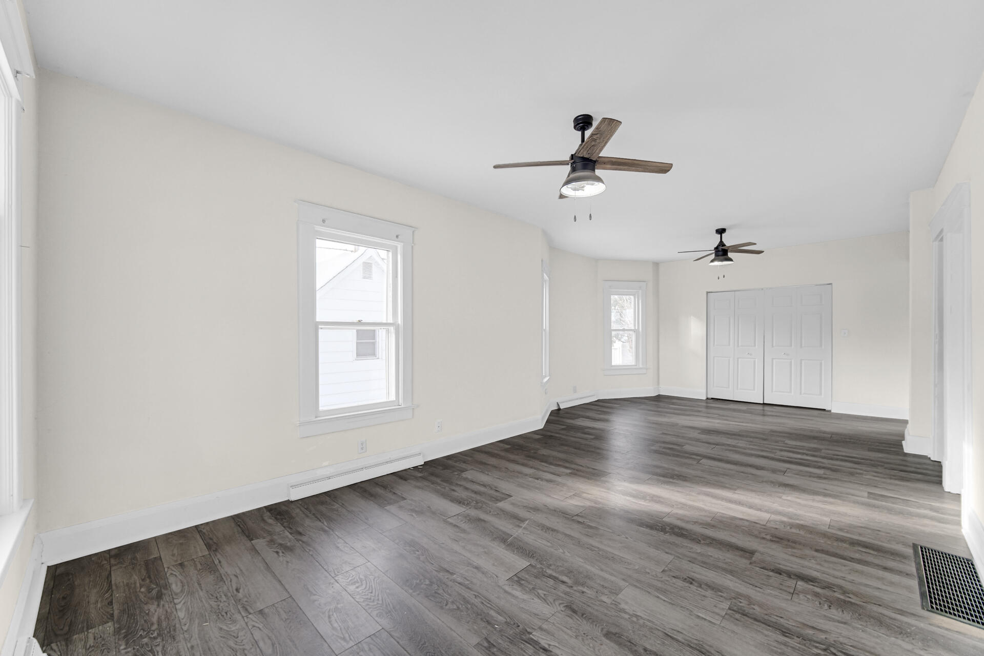 404 F Street La Porte, IN 46350 - Photo 14 of 35 an empty room with wooden floor ceiling fan and window