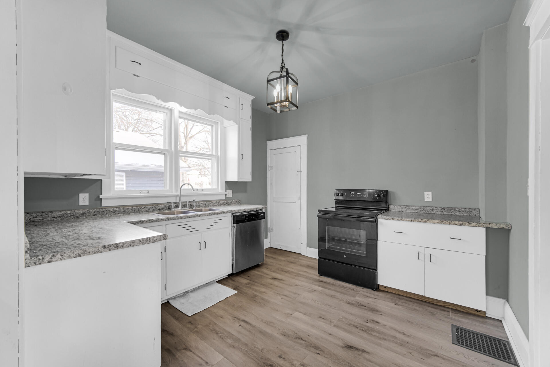 404 F Street La Porte, IN 46350 - Photo 17 of 35 a kitchen with a stove white cabinets and sink