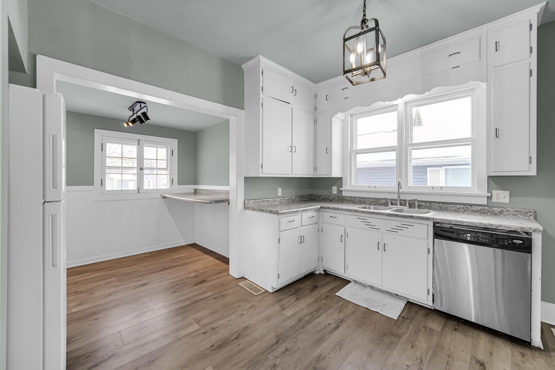 404 F Street La Porte, IN 46350 - Photo 19 of 35 a kitchen with granite countertop white cabinets and a large window