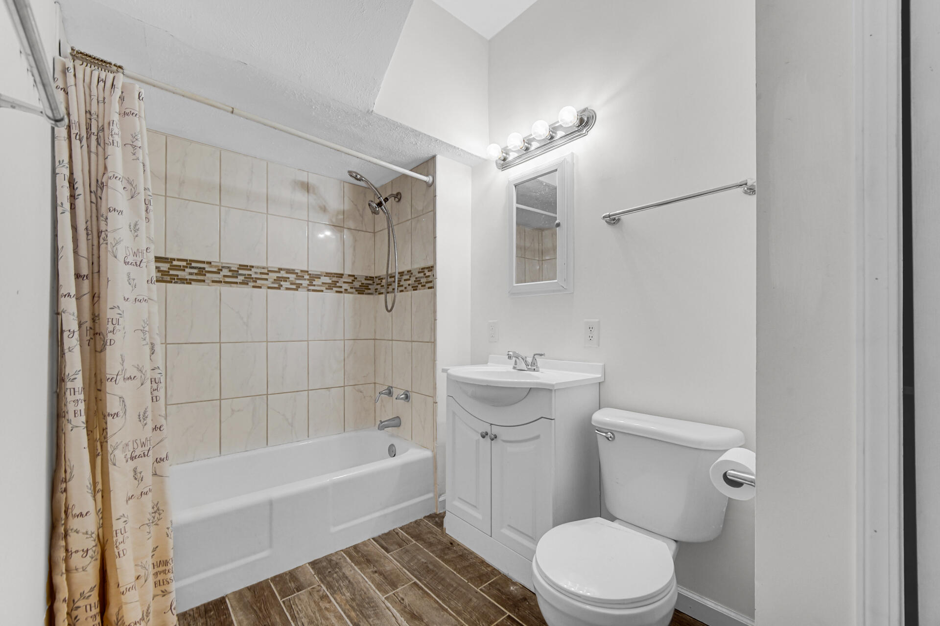 404 F Street La Porte, IN 46350 - Photo 25 of 35 a bathroom with a sink a toilet a mirror and shower