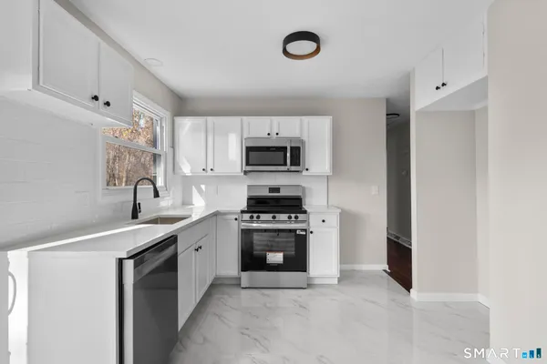 a kitchen with a sink stove and microwave