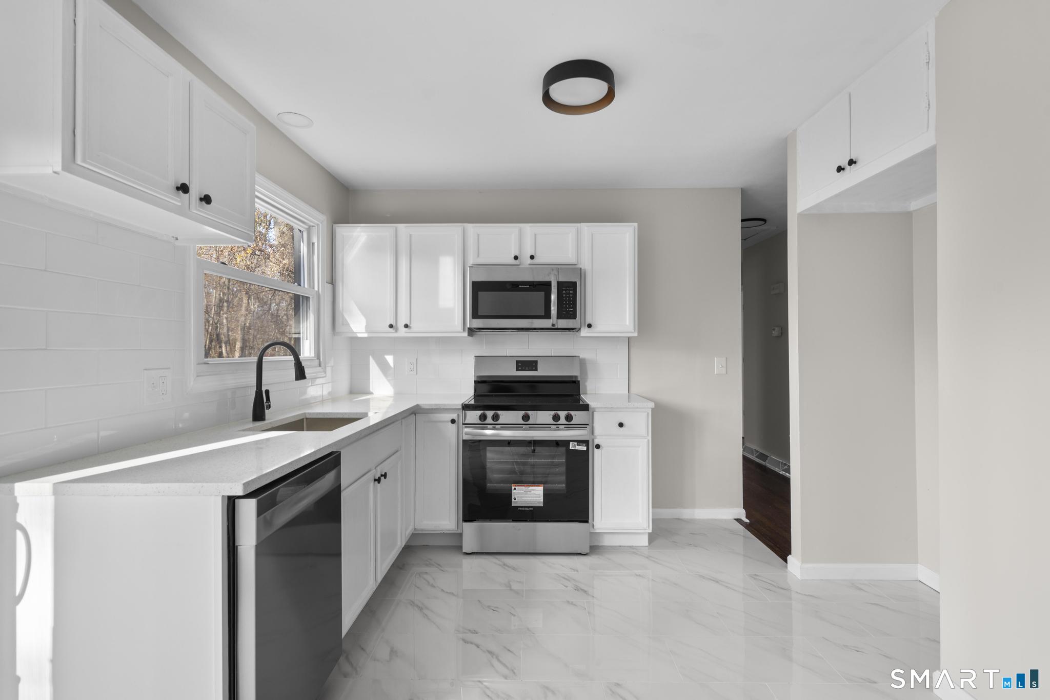 19 Ironworks Road Clinton, CT 06413 - Photo 1 of 1 a kitchen with a sink stove and microwave