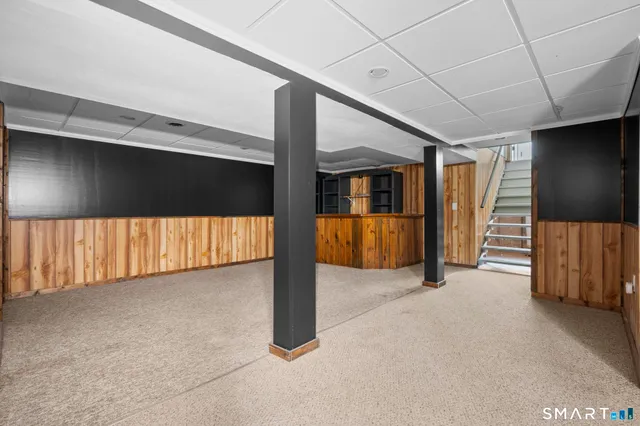 a view of a livingroom with wooden floor and furniture