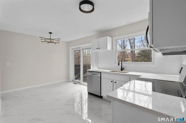 a large white kitchen with a window