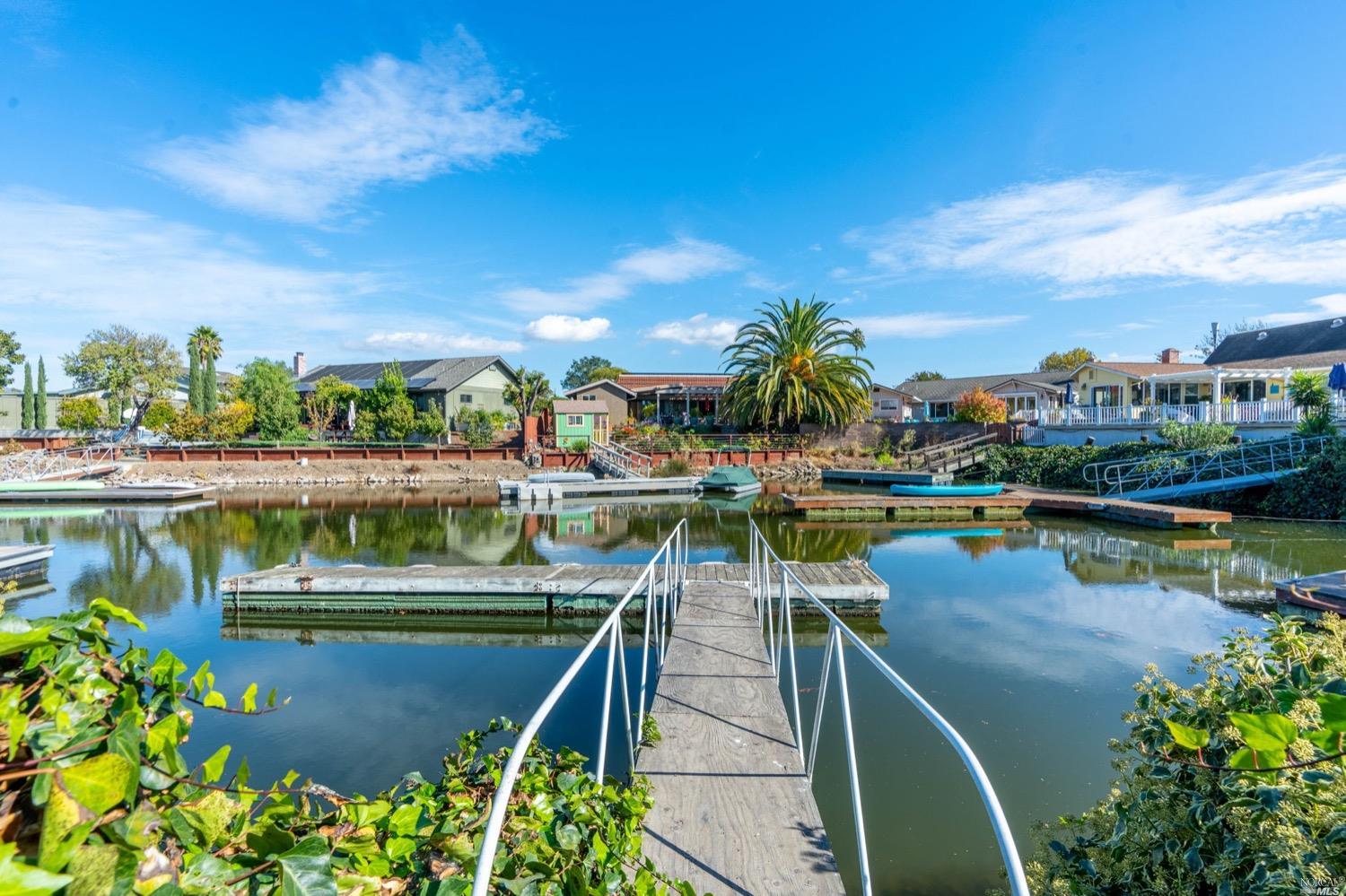 a view of a lake with a table and chairs