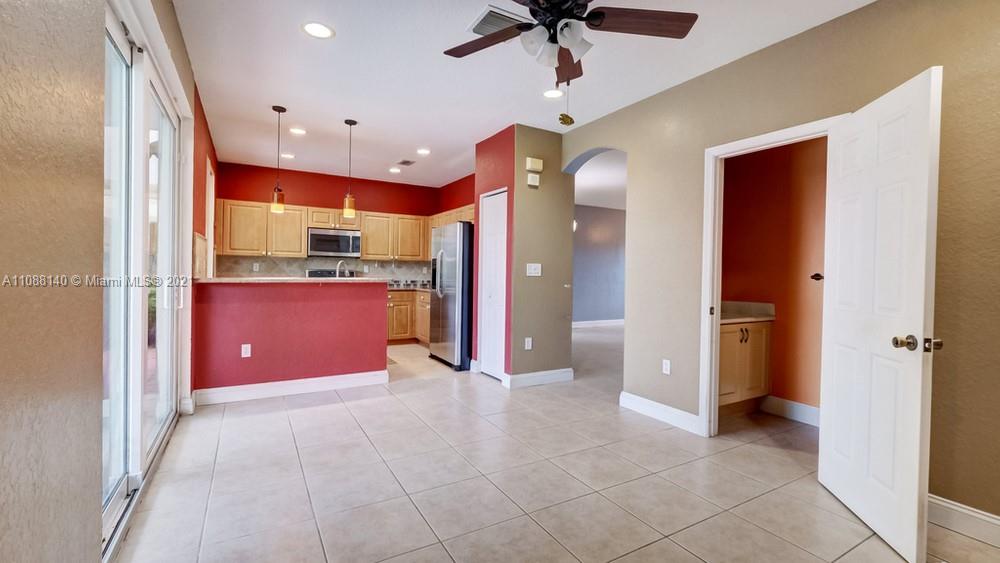1311 Southeast 20th Road, Unit 1311 Homestead, FL 33035 - Photo 11 of 40 a view of a kitchen with a sink and a refrigerator