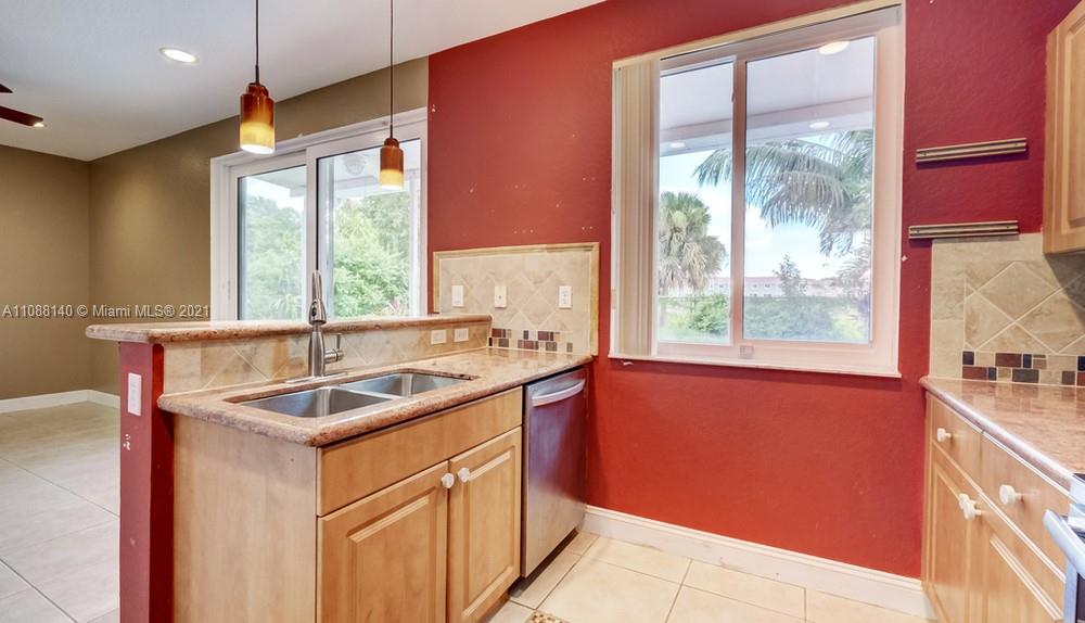 1311 Southeast 20th Road, Unit 1311 Homestead, FL 33035 - Photo 15 of 40 a kitchen that has a sink and a window