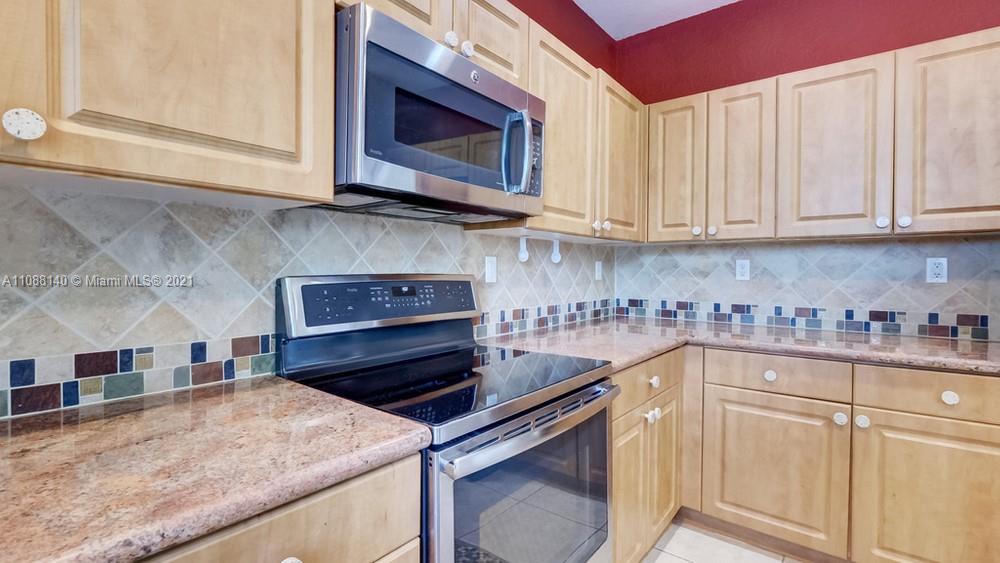 1311 Southeast 20th Road, Unit 1311 Homestead, FL 33035 - Photo 18 of 40 a kitchen with stainless steel appliances granite countertop a sink stove and cabinets