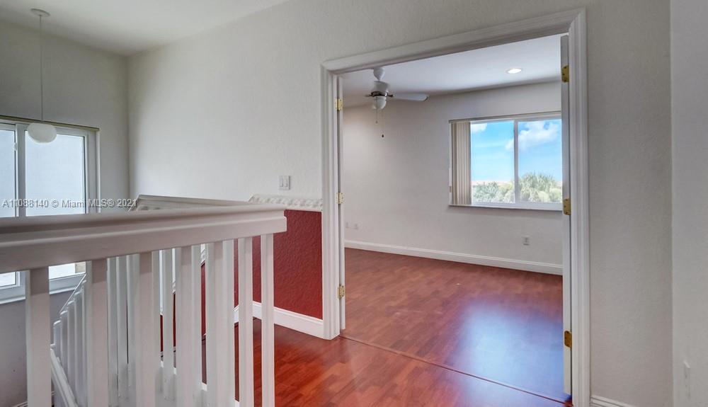 1311 Southeast 20th Road, Unit 1311 Homestead, FL 33035 - Photo 25 of 40 a view of an empty room with wooden floor and a window
