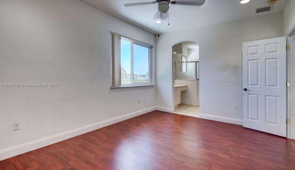 1311 Southeast 20th Road, Unit 1311 Homestead, FL 33035 - Photo 27 of 40 wooden floor in an empty room with a window