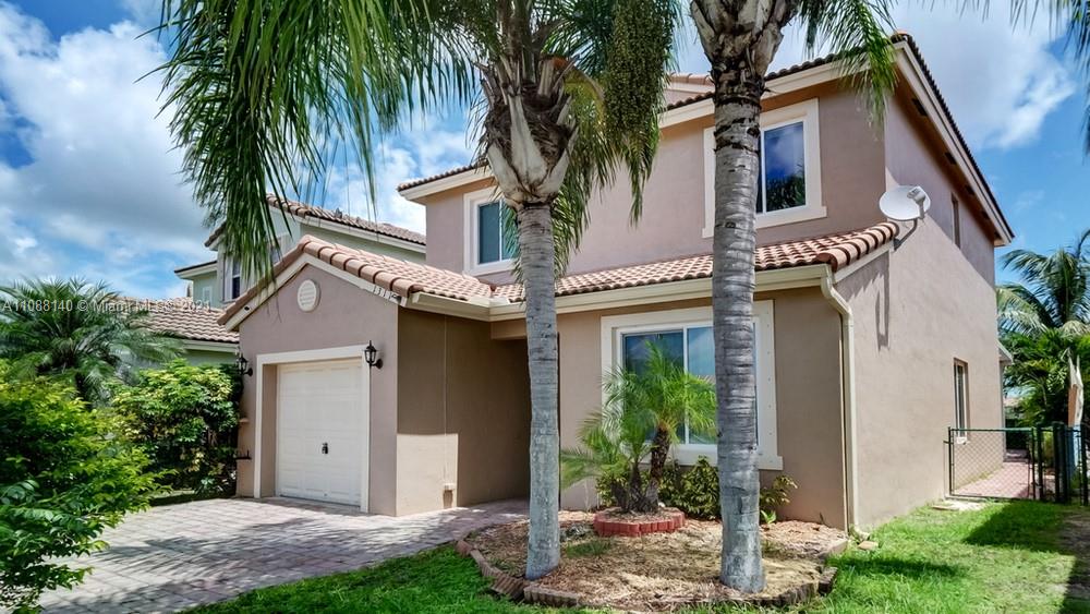 1311 Southeast 20th Road, Unit 1311 Homestead, FL 33035 - Photo 3 of 40 a front view of house with yard
