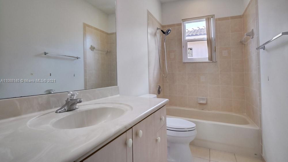1311 Southeast 20th Road, Unit 1311 Homestead, FL 33035 - Photo 32 of 40 a bathroom with a granite countertop sink a toilet and shower