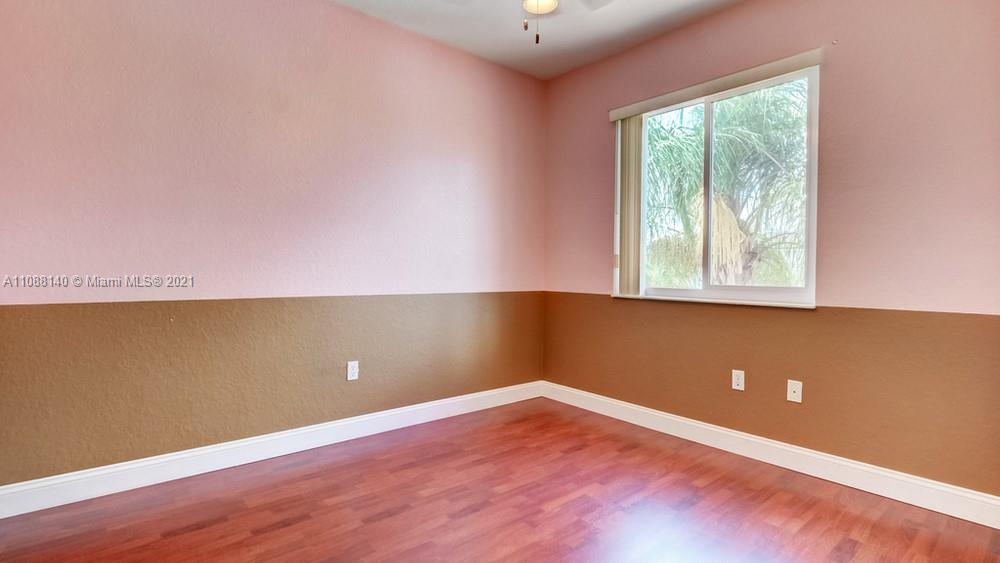 1311 Southeast 20th Road, Unit 1311 Homestead, FL 33035 - Photo 33 of 40 an empty room with wooden floor and windows