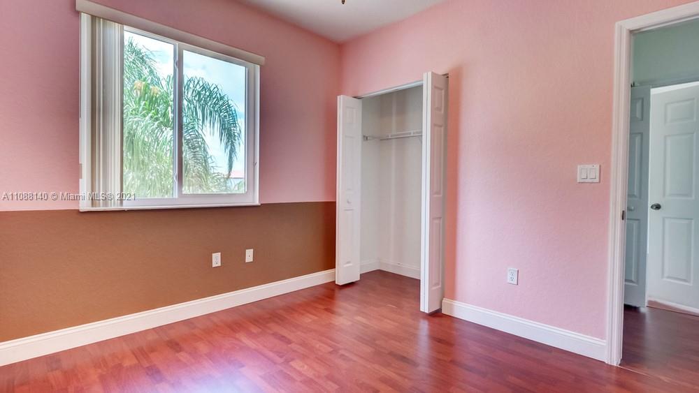 1311 Southeast 20th Road, Unit 1311 Homestead, FL 33035 - Photo 34 of 40 an empty room with wooden floor and windows