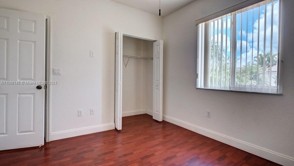 1311 Southeast 20th Road, Unit 1311 Homestead, FL 33035 - Photo 36 of 40 an empty room with wooden floor and windows