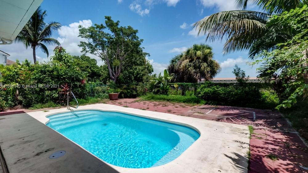 1311 Southeast 20th Road, Unit 1311 Homestead, FL 33035 - Photo 38 of 40 a view of a swimming pool with a yard