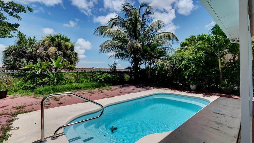 1311 Southeast 20th Road, Unit 1311 Homestead, FL 33035 - Photo 39 of 40 a view of a backyard with plants and tree