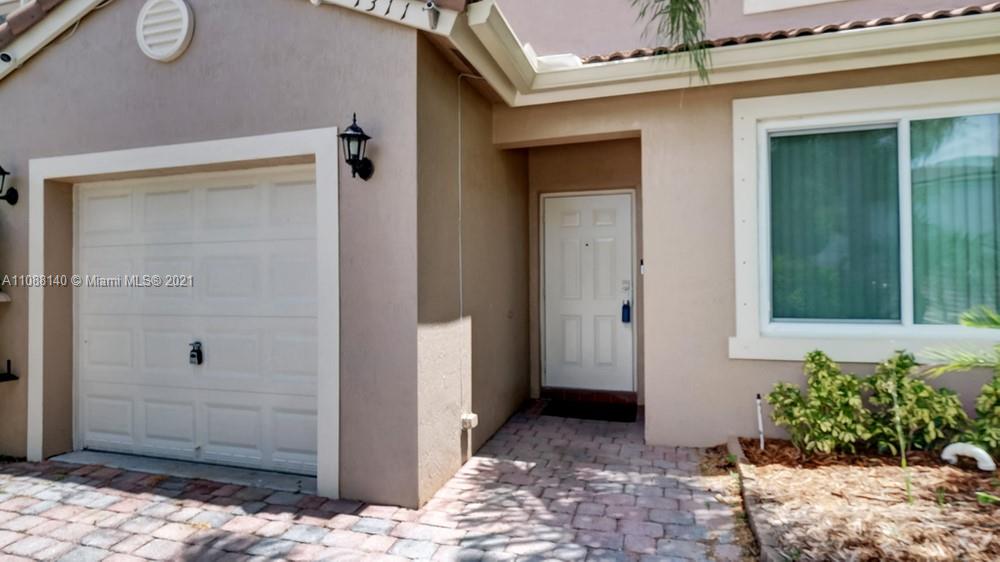 1311 Southeast 20th Road, Unit 1311 Homestead, FL 33035 - Photo 4 of 40 a view of a wooden door