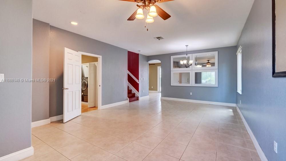 1311 Southeast 20th Road, Unit 1311 Homestead, FL 33035 - Photo 6 of 40 a view of an empty room with window and wooden floor