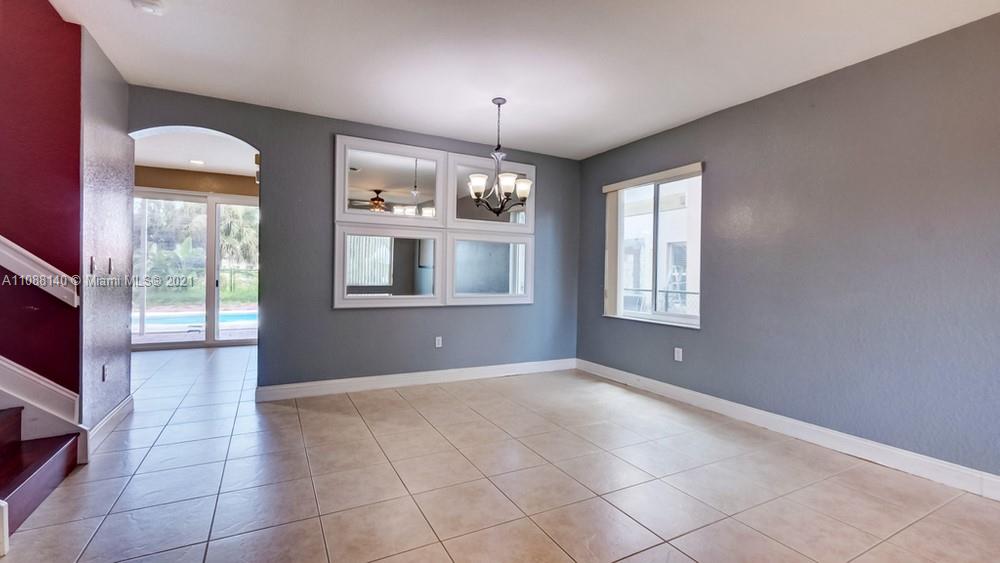 1311 Southeast 20th Road, Unit 1311 Homestead, FL 33035 - Photo 7 of 40 a view of an empty room with a window