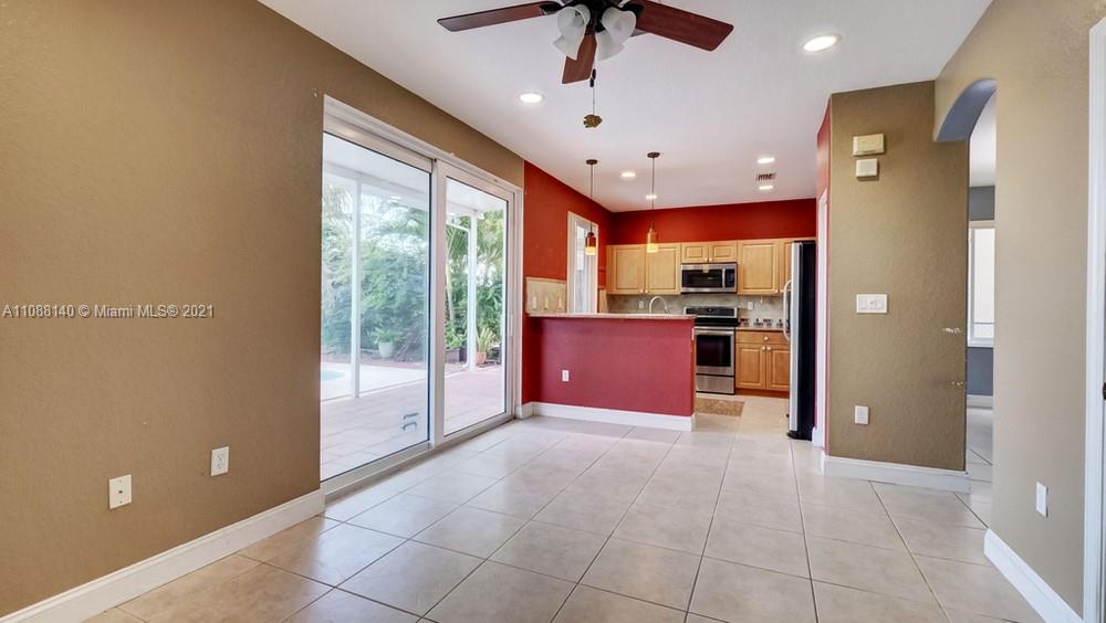 1311 Southeast 20th Road, Unit 1311 Homestead, FL 33035 - Photo 10 of 40 a large kitchen with stainless steel appliances granite countertop a refrigerator and a sink