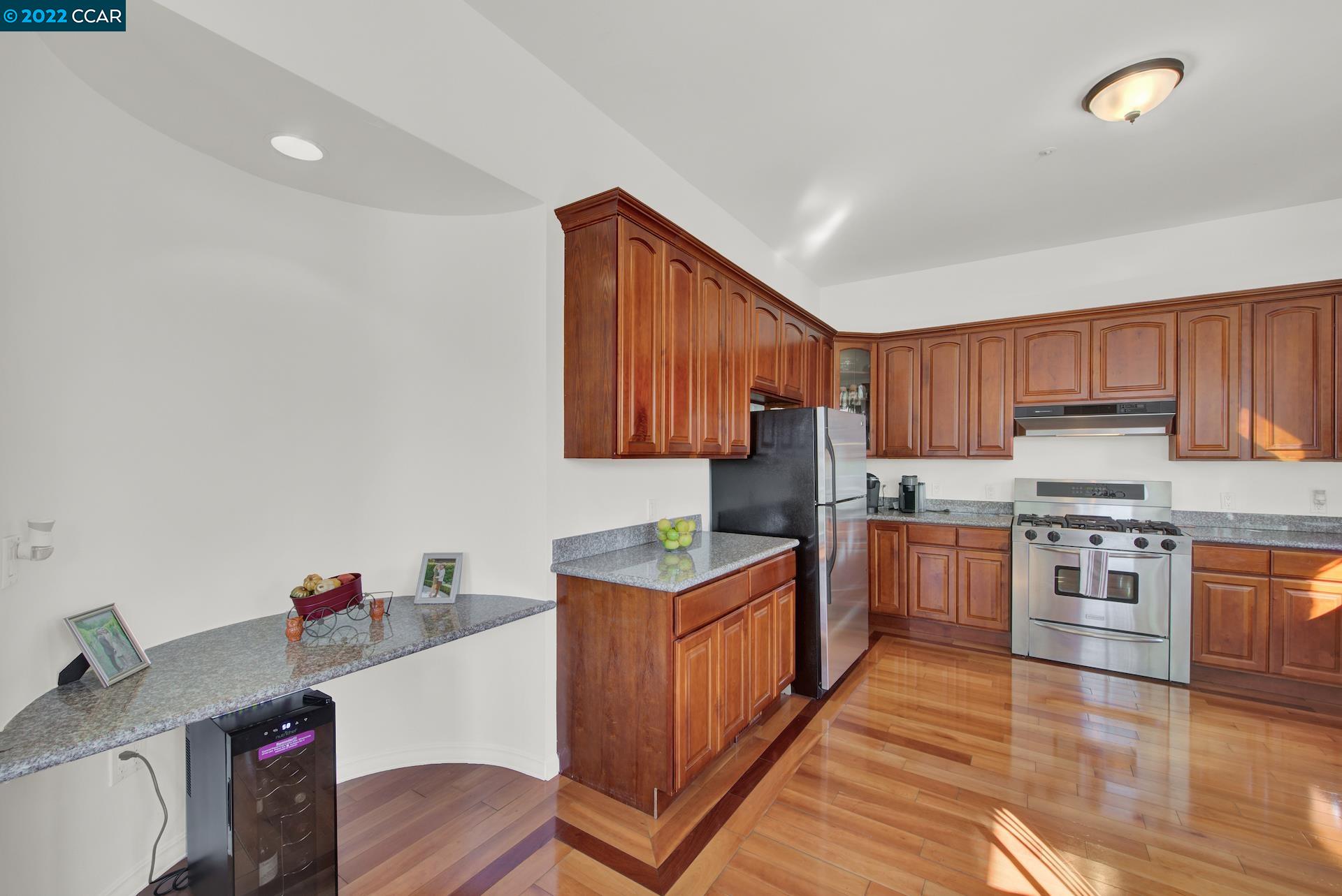 2004 Main Street Napa, CA 94559 - Photo 3 of 7 a kitchen with stainless steel appliances granite countertop a stove top oven a sink dishwasher and a refrigerator with wooden cabinets