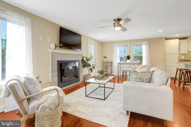 a living room with furniture fireplace and flat screen tv